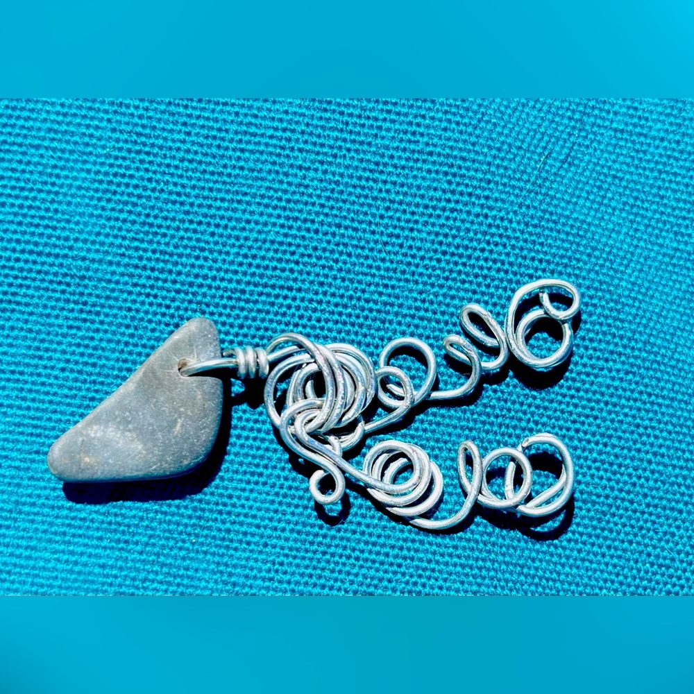 Wire wrapped natural finger lakes lucky stone pendant.